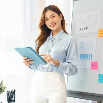 Successful business concept, Businesswoman smiling and using tablet to reading financial report.